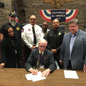 Mayor Siver (seated center) signing State of Emergency Proclamation 